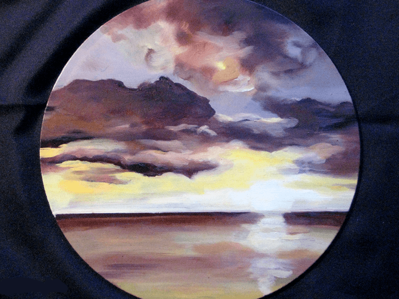 Circular painting of a sunset over open water, worked onto dark cloth.