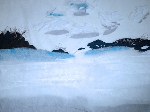 Felted wool landscape — pale blue mountains above a white shoreline, made for TAMRINATOR.